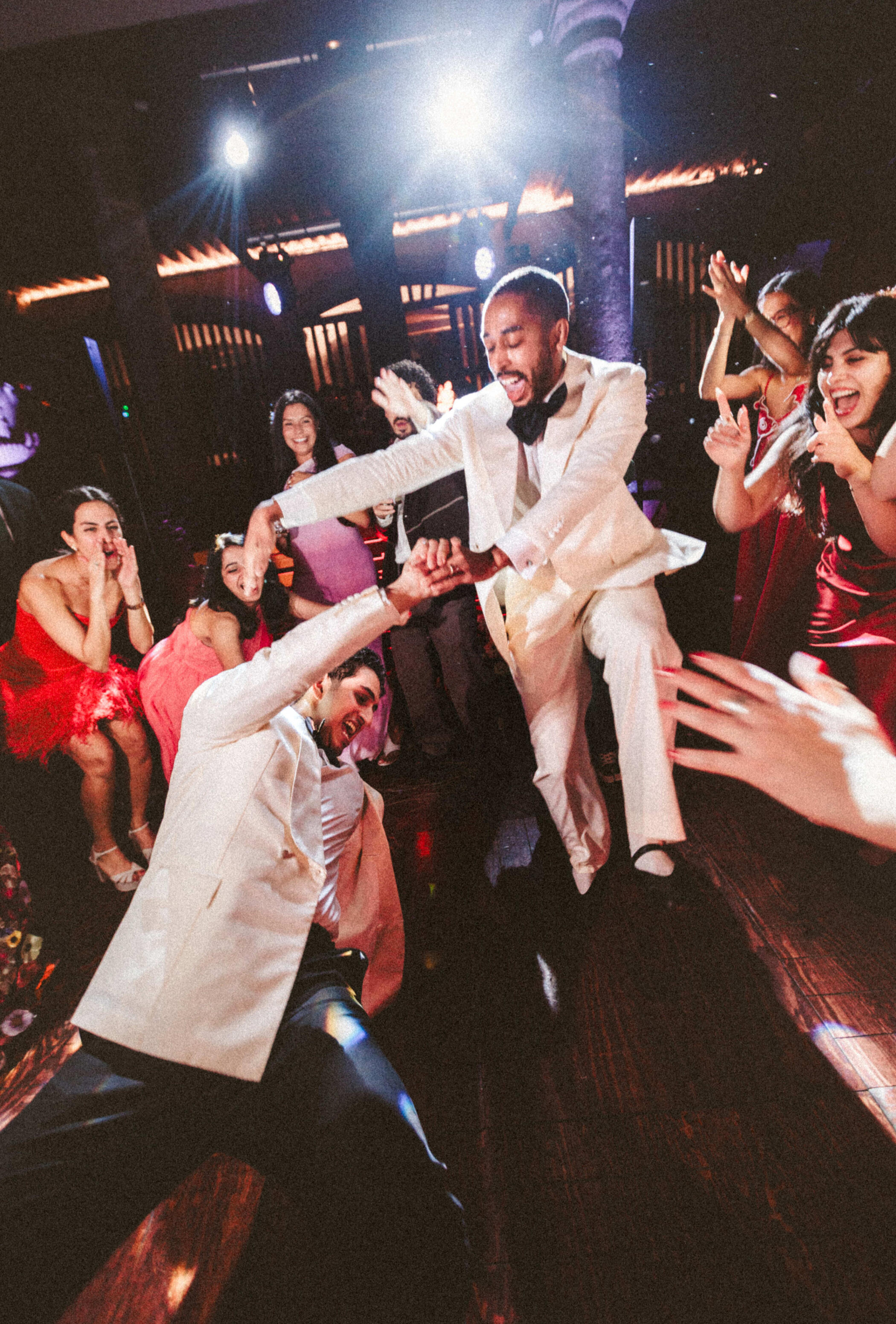 Wedding guests celebrating on a packed dance floor